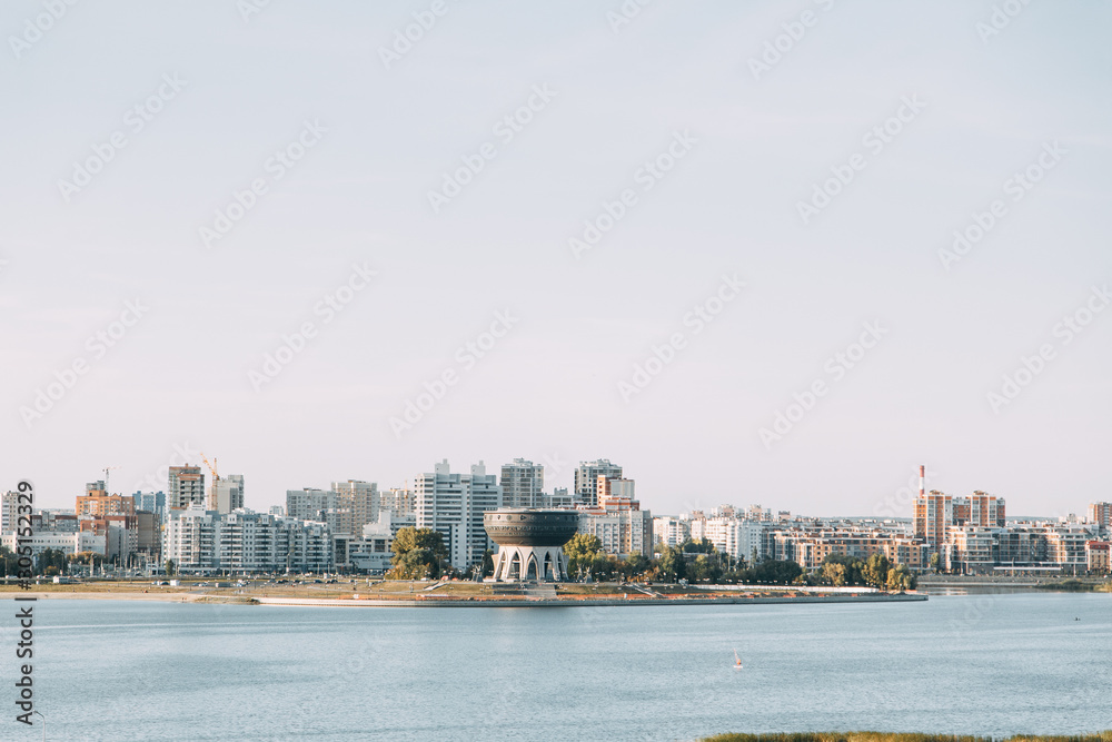  Silhouette of a modern city. Day panorama of Kazan and the river.