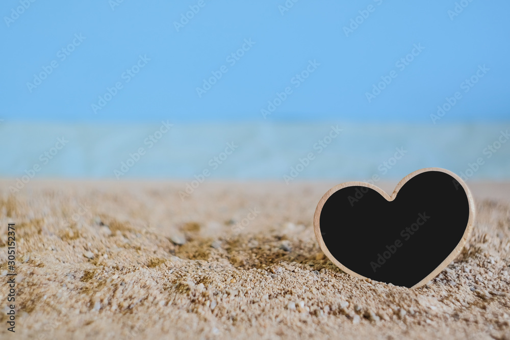 Fototapeta premium Heart sign wood with tropical sand beach ,love concept and soft focus.