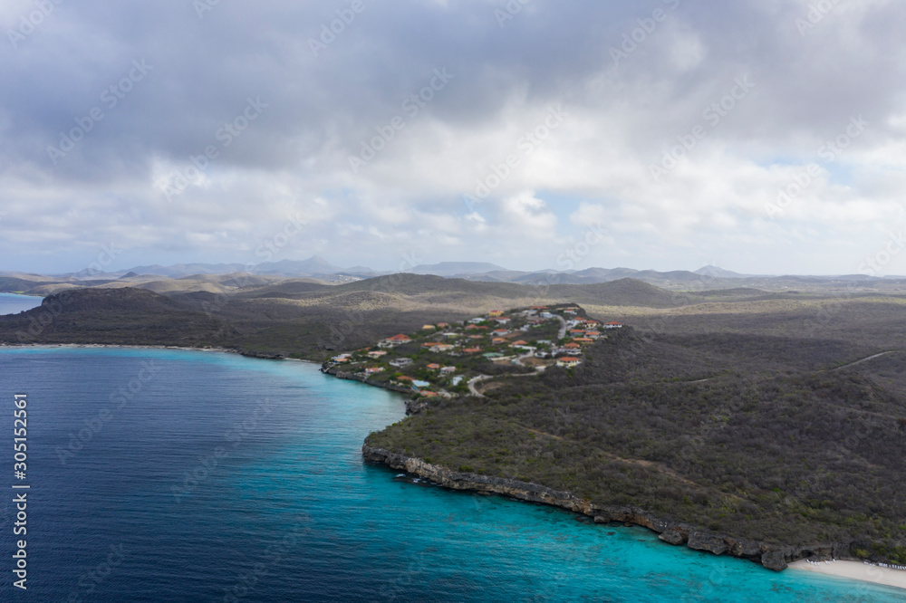 Aerial view of coast of Curaçao in the Caribbean Sea with turquoise water, cliff, beach and beautiful coral reef around Playa  Cas Abao