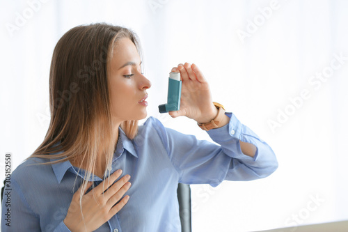 Young woman with inhaler ha...