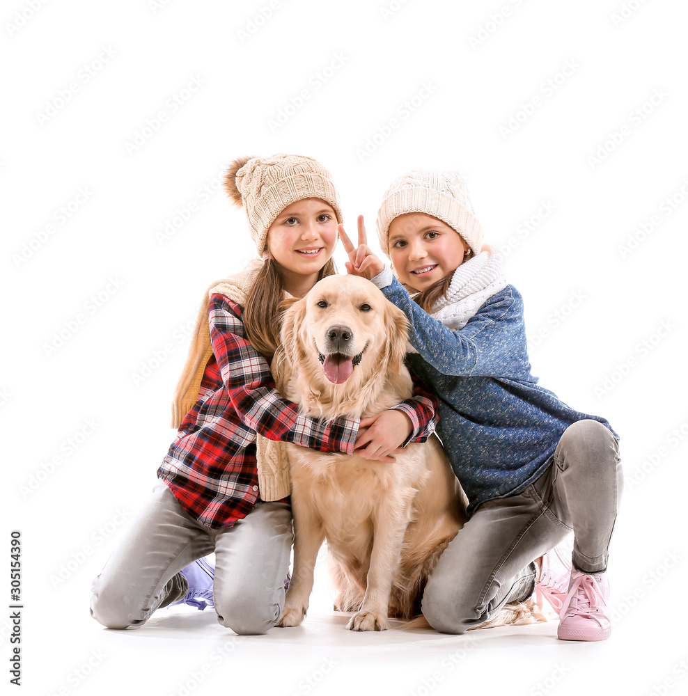 Happy girls in autumn clothes and with dog on white background