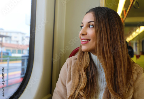 Free Download Young woman looking through the window sitting on moving tram. - GFXLoad