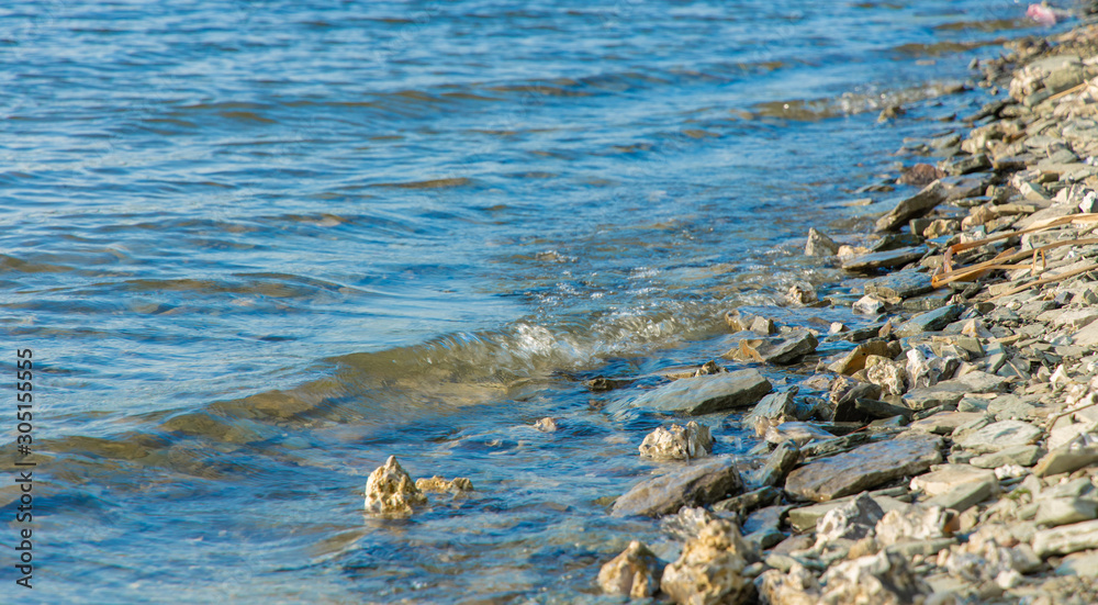 simple natural background scenic view of lake blue water coast with stones simple natural background scenic view of lake blue water coast with stones