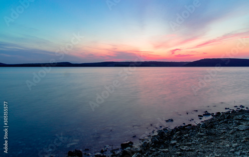 long exposure landscape photography of evening lake coast line silent peaceful view wallpaper pattern with empty copy space for your text 