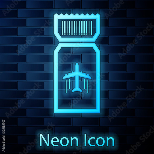 Glowing neon Airline ticket icon isolated on brick wall background. Plane ticket.  Vector Illustration