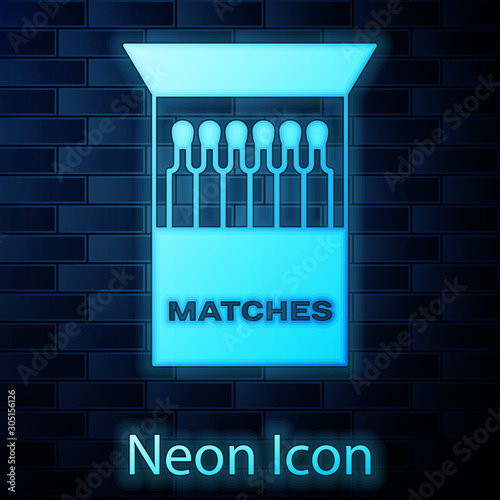 Glowing neon Open matchbox and matches icon isolated on brick wall background.  Vector Illustration