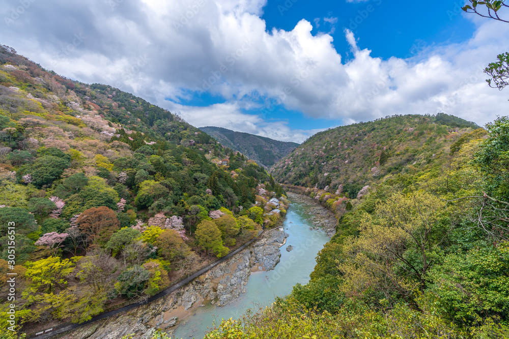 Beautiful colorful forest mountains and river with blue sky view at katsura river lake to Arashiyama mountain Kyoto, Japan. idea for rest relax enjoy lifestyle