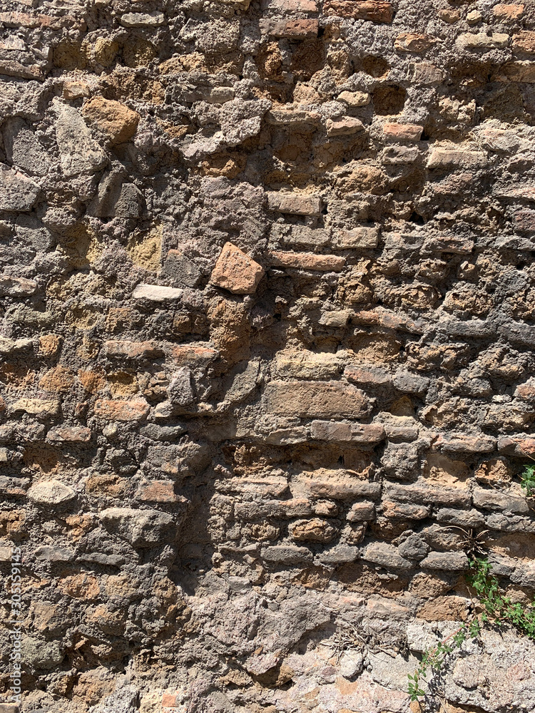 Fototapeta premium old antique stone ruined brown brick wall