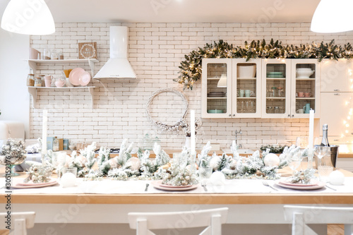 Beautiful table setting for Christmas celebration in kitchen © Pixel-Shot