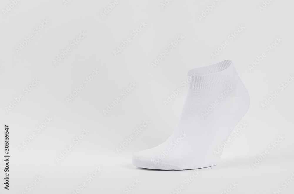 Blank white cotton short sock on invisible foot on white background as mock up for advertising, branding, design, front view, template. Blank white cotton short sock on invisible foot on white background as mock up for advertising, branding, design, front view, template.