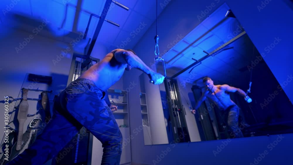 Man in gym working out. Handsome bodybuilder works out pushing up excercise in gym in front of the mirror Man in gym working out. Handsome bodybuilder works out pushing up excercise in gym in front of the mirror