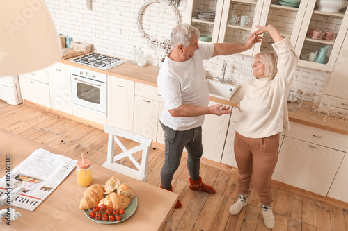 Happy mature couple dancing...