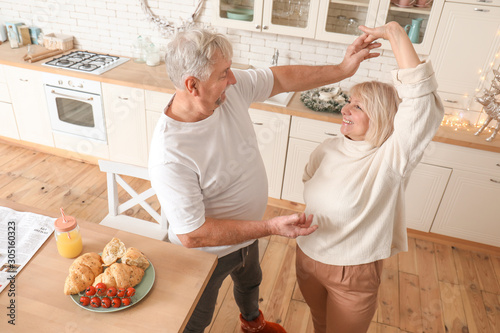 Happy mature couple dancing...