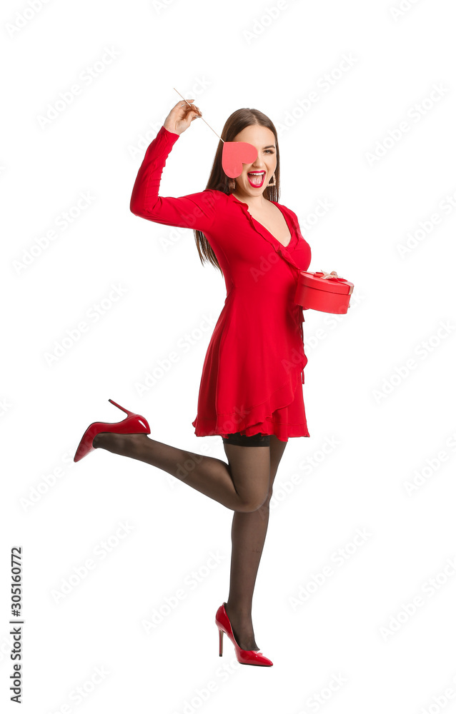 Beautiful young woman with red heart and gift on white background. Valentine's Day celebration Beautiful young woman with red heart and gift on white background. Valentine's Day celebration