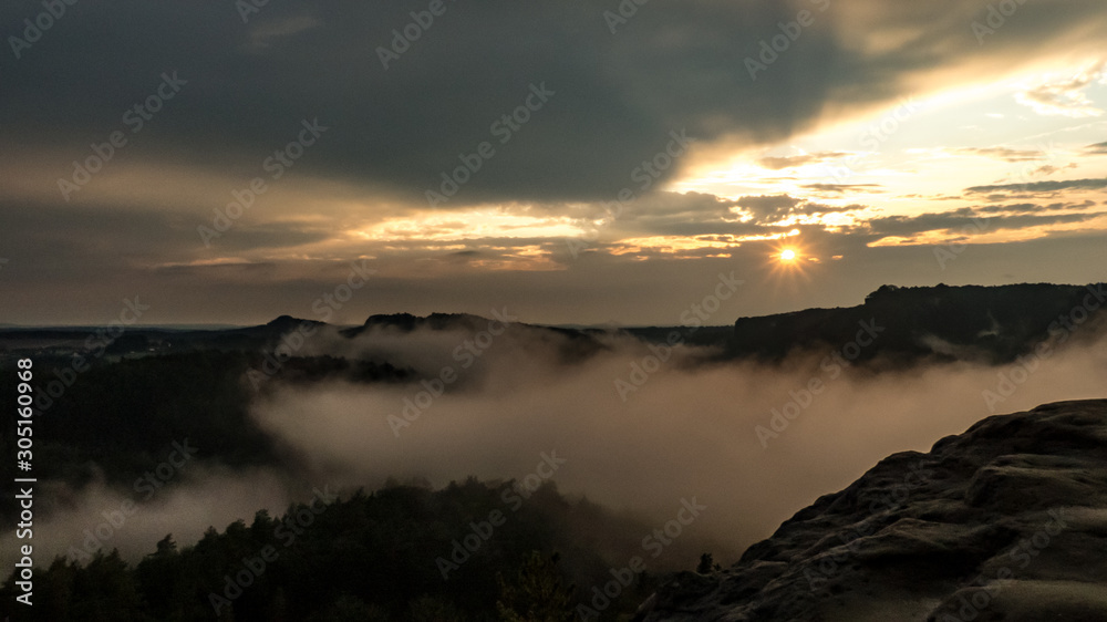 View from Gamrig over the foggy Elbe valley in Saxon Switzerland at sunset