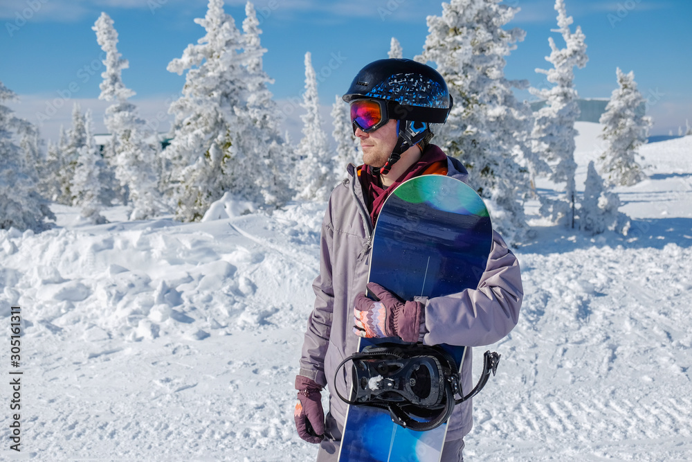 Young snowboarder riding in the mountains on a snowboard. Young snowboarder riding in the mountains on a snowboard.