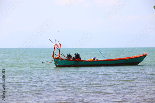 Traditional Khmer fishing boat anchored on the coast of Kep Cambodia that shows the beauty and everyday life of the country