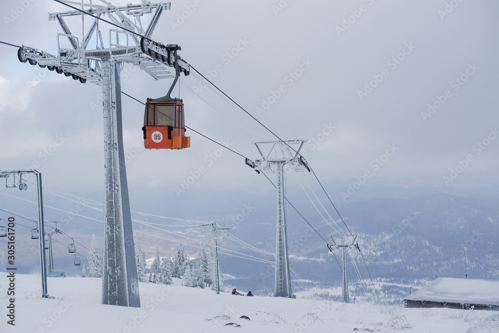 Funicular for tourists, skiers and snowboarders. lift to transport people in the mountains. the cable car on the background of blue mountains.