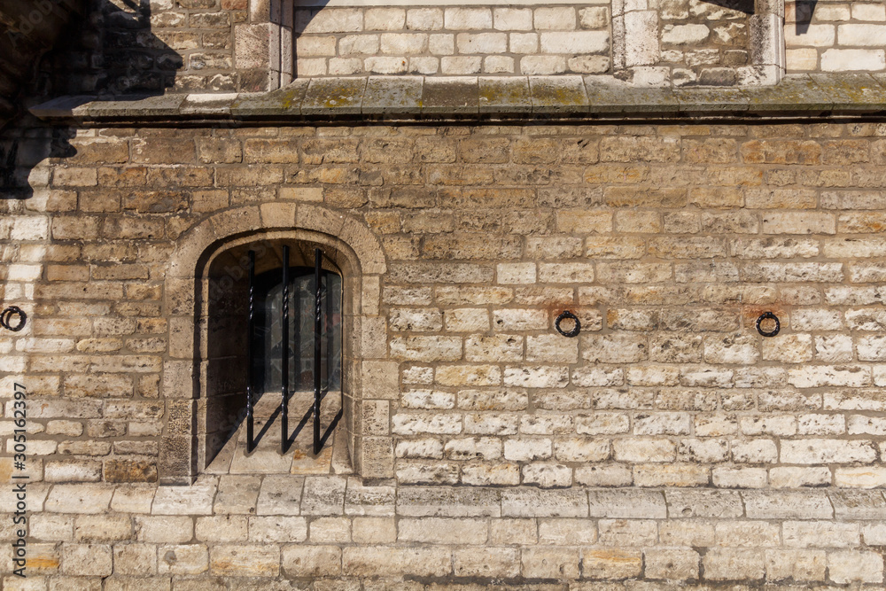 Naklejka premium Abstract medieval brick wall with barred window