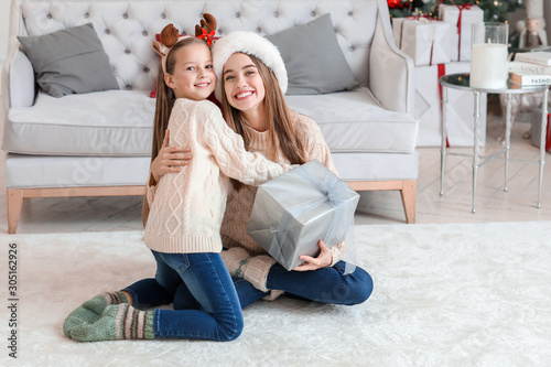Little girl giving Christma...