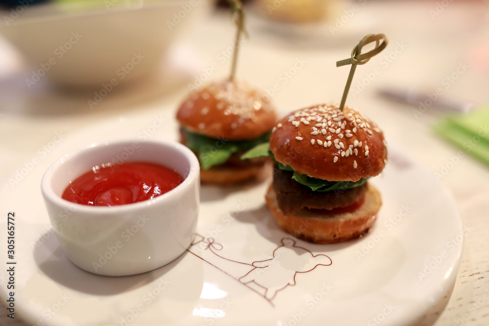 Fototapeta premium Two mini burgers and ketchup