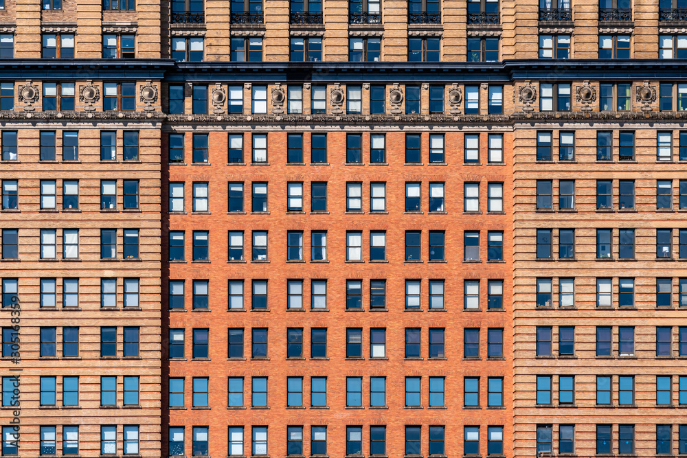 Brown Brick high building facade with windows in New York City, United states of America, USA, Industrial Background and texture, Loft inspiration. Construction facade, history and culture concept