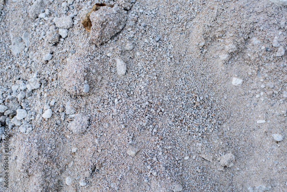 A large pile of gray sand. Background. Texture.