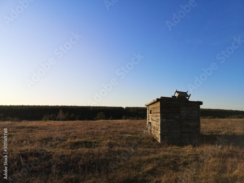  abandoned wooden hut in the field