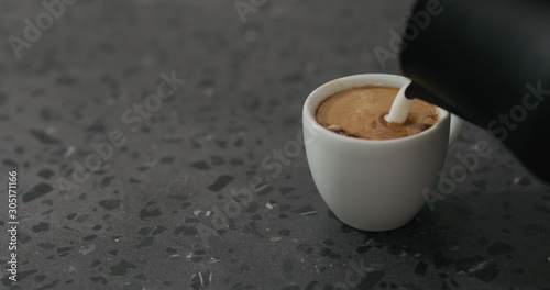 steamed milk pour into espresso