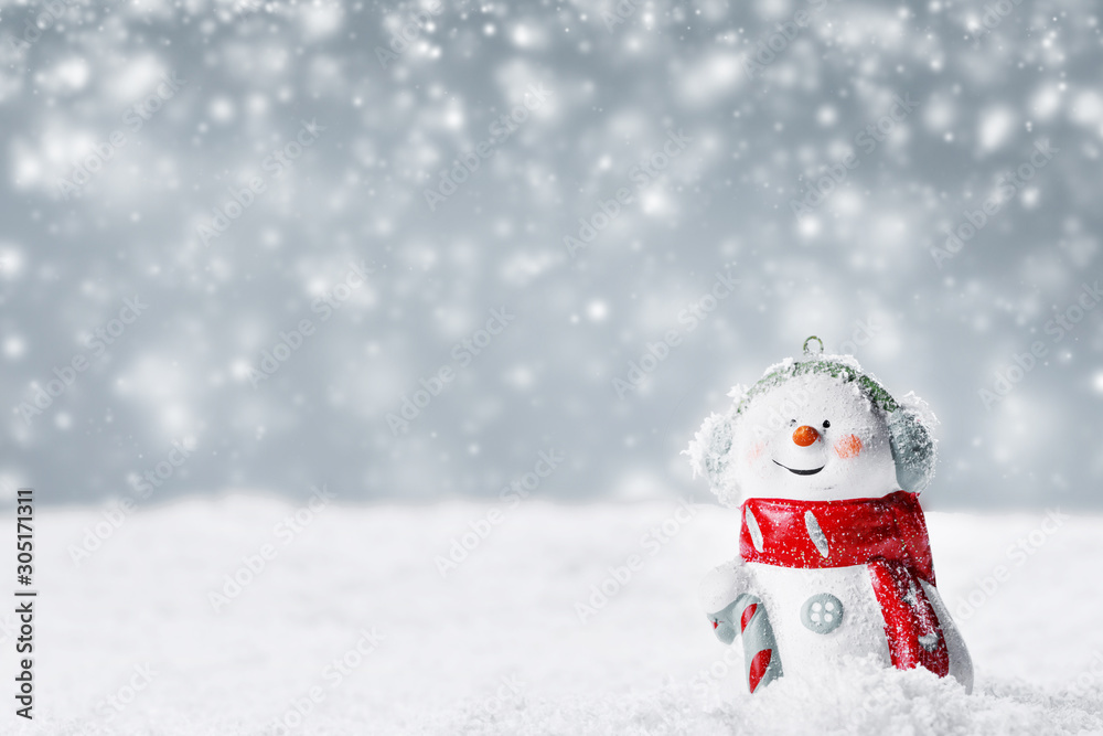 Snowman toy on winter background