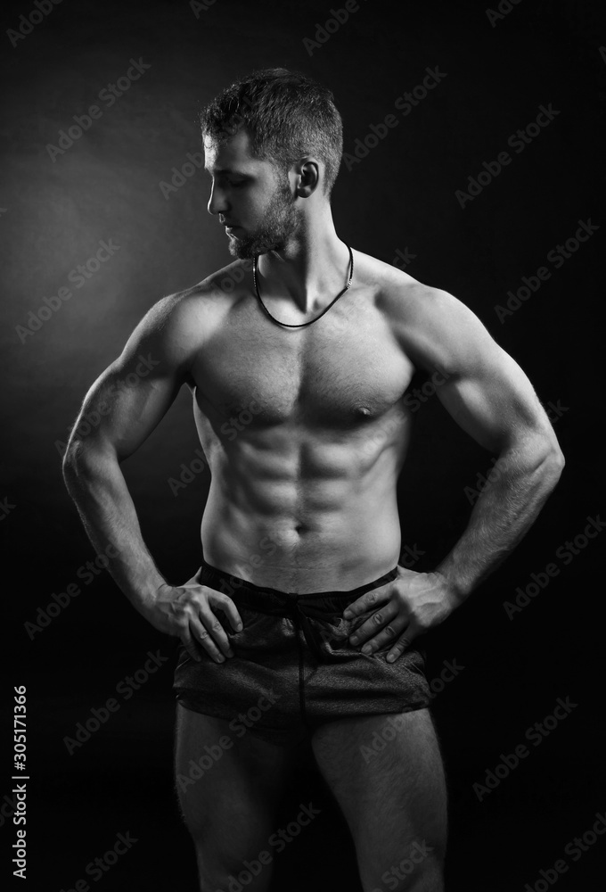 Brutal strong bodybuilder athletic fitness man pumping up muscles workout bodybuilding. Brutal strong bodybuilder athletic fitness man pumping up muscles workout bodybuilding.