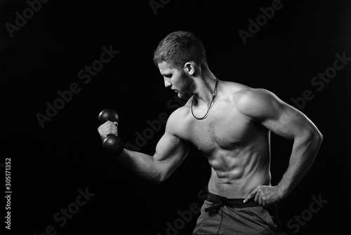 Brutal strong bodybuilder athletic fitness man pumping up muscles workout bodybuilding. © Igor Normann