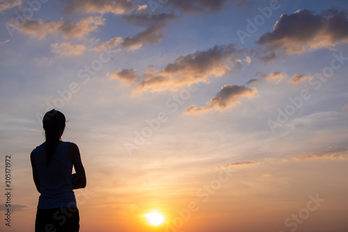 Free young woman at golden sunset. Freedom and success concept,relaxing and enjoying nature with copy space.