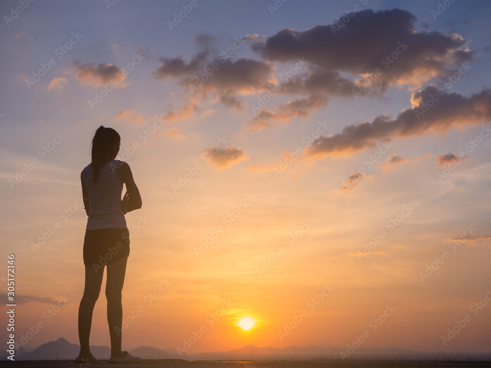 Free young woman at golden sunset. Freedom and success concept,relaxing and enjoying nature with copy space.