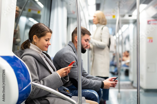 Girl with phone in metro car