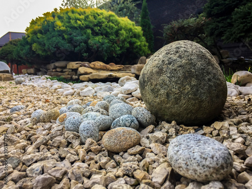 Stones of different types against the background of bushes