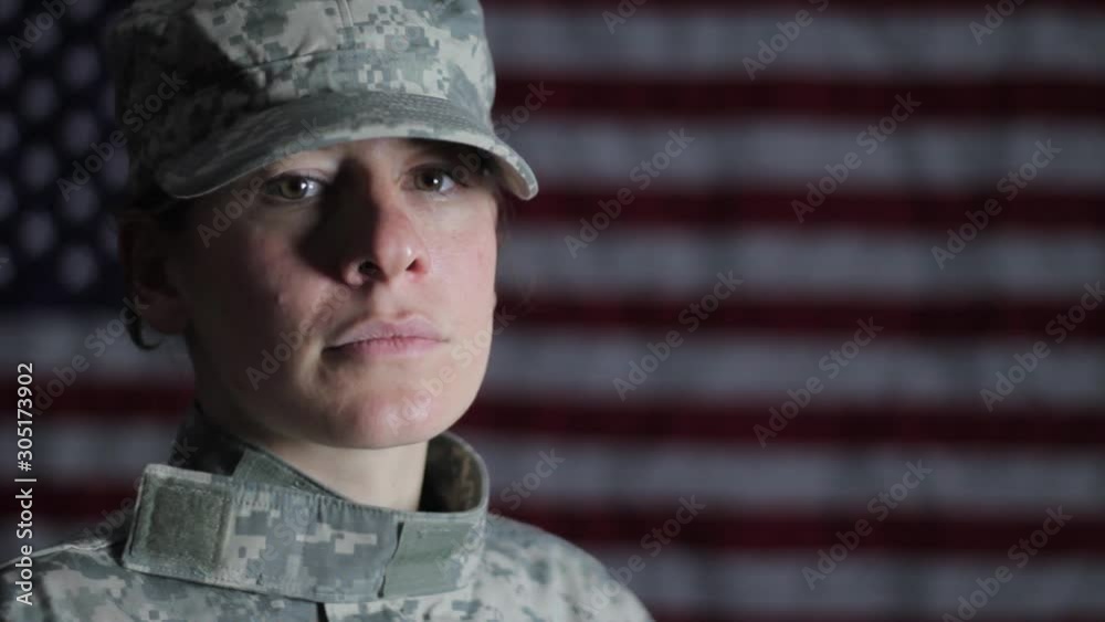 American female soldier against an American flag American female soldier against an American flag