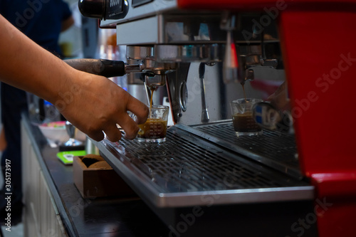 espresso shot in barista making coffee