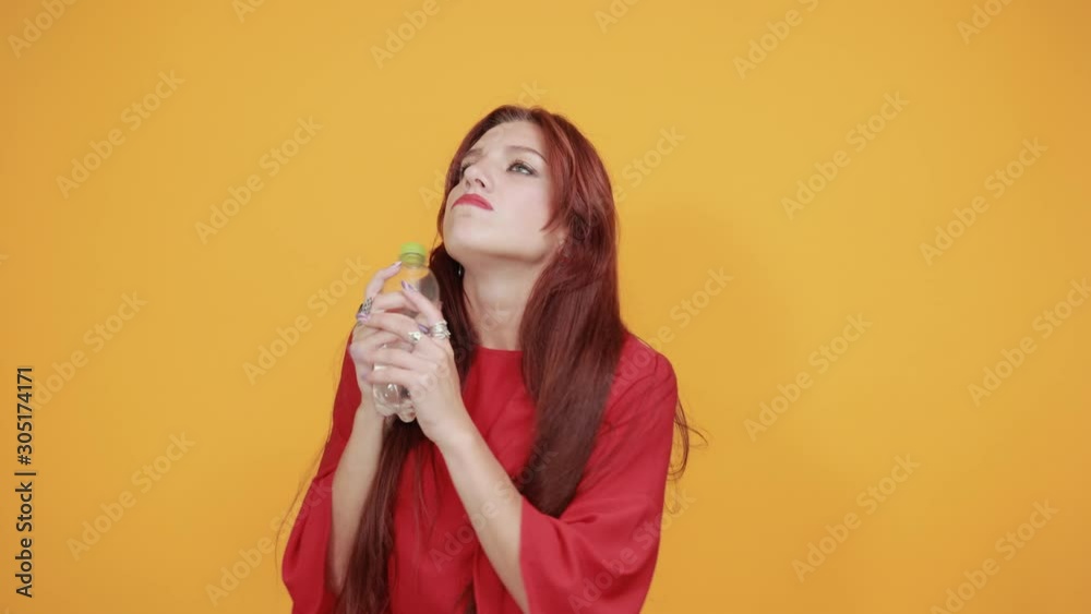 Classy red lady is spreading awareness of drinking water. She is drinking water, and she loves to drink water as it is natural cleanser for the skin.