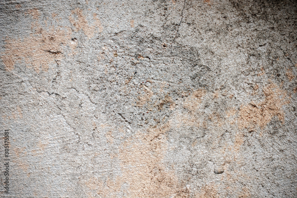 Fototapeta premium Dark plaster wall with dirty cracked scratched background. Old retro vintage brickwall with peel grey stucco texture