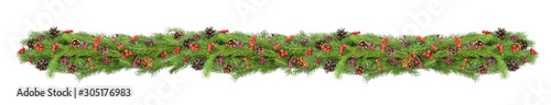 Christmas garland of fresh spruce branches with red berries and pine cones. Decorative border. Christmas holiday, New Year, winter concept.