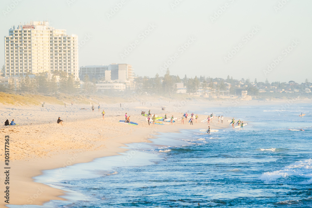 Beautiful views at golden hour of the sunset over the beach and ocean with people out to enjoy the summer lifestyle Trigg, Perth, Western Australia has to offer.
