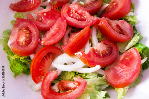 bowl with lettuce and tomato salad, diet and food concept