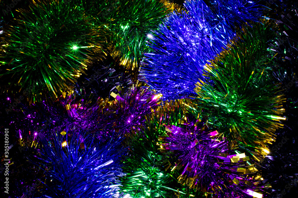Fototapeta premium Bright multi-colored shiny Christmas garlands for decorating the Christmas tree and home, close-up