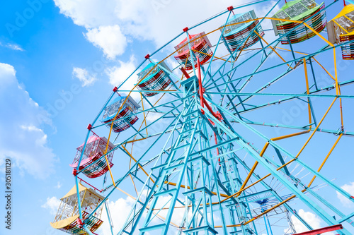 Ferris wheel on the background of blue sky Colourful Vintage Ferris wheel