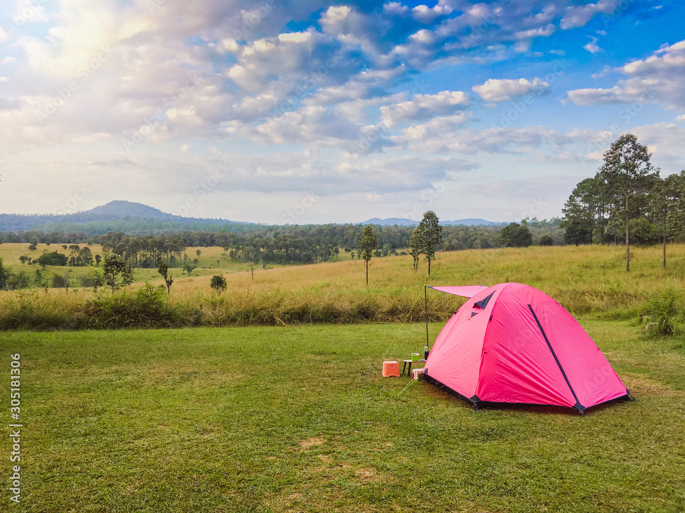 Camping tent on view point of mountain with blue sky and Hill of Savannah background.Concept equipment for adventure and travel.