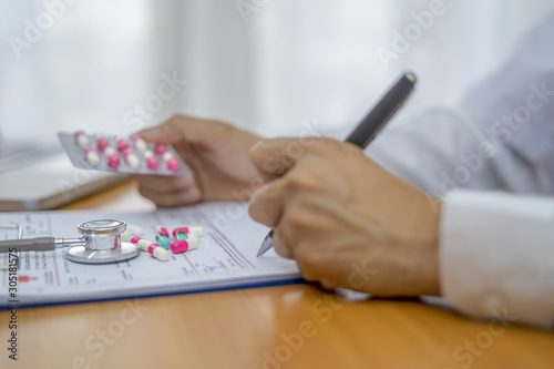 The doctor wrote a prescription in a special form. Medical care concepts, pharmacies, or insurance