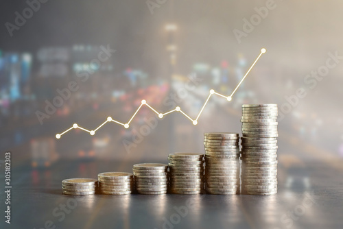 Double exposure stack of Thailand coins on black wooden table with profit graph, growth up, success on blur background of night road. Business, finance, marketing, e-commerce concept and design