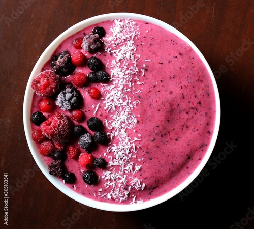 Pink smoothie bowl red fruits