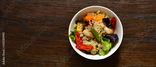 Salad with quinoa, sweet pepper, mushrooms, herbs and pistachios. Healthy nutrition. Vegetarian concept, top view, copy space